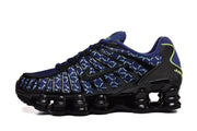 Side view of blue patterned Nike Shox TL sneakers with black overlays and sculpted soles.