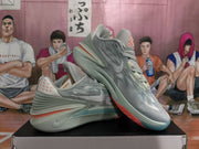 Angled side view showing the grey-blue textured upper, Nike side branding, layered midsole, and orange outsole accent.