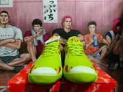 Front view of a pair of yellow Nike sneakers with red detailing, white toe areas, and red tongue logos.