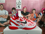 Side profile of one red and white basketball sneaker showing the patterned upper, black Swoosh, sculpted heel, and contrasting sole.
