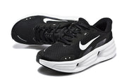Pair of black Nike Comfort Ride EasyOn sneakers with white Swoosh details and thick white midsoles.