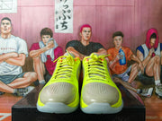 Front view showing the neon green laces, perforated gray toe panels, and translucent outsoles.