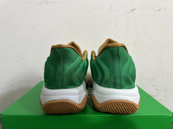 Rear view of green Nike basketball shoes with white midsoles and gum-colored outsoles.