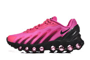 Side view of a pink and black Air Max DN 8 sneaker with rounded visible cushioning elements along the sole.