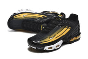 Angled view of black and yellow Nike Air Max Plus III sneakers.