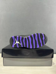 Outsole view showing black and purple tread sections and basketball-themed lettering.