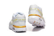 Rear view of white Nike Air Max sneakers with gold heel accents and visible Air units.