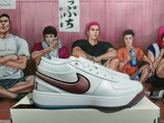 Side view of a white low-top sneaker with a burgundy swoosh-style side accent and contrasting outsole.