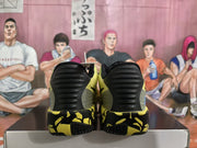 Rear view of the yellow and black Nike basketball sneakers, showing black heel panels and patterned soles.