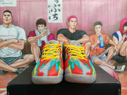 Front view of the pair showing yellow laces and multicolor patterned toe boxes.