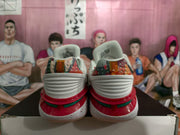 Rear view of the sneakers showing patterned heel panels, ribbed white heel sections, and red and green outsole details.