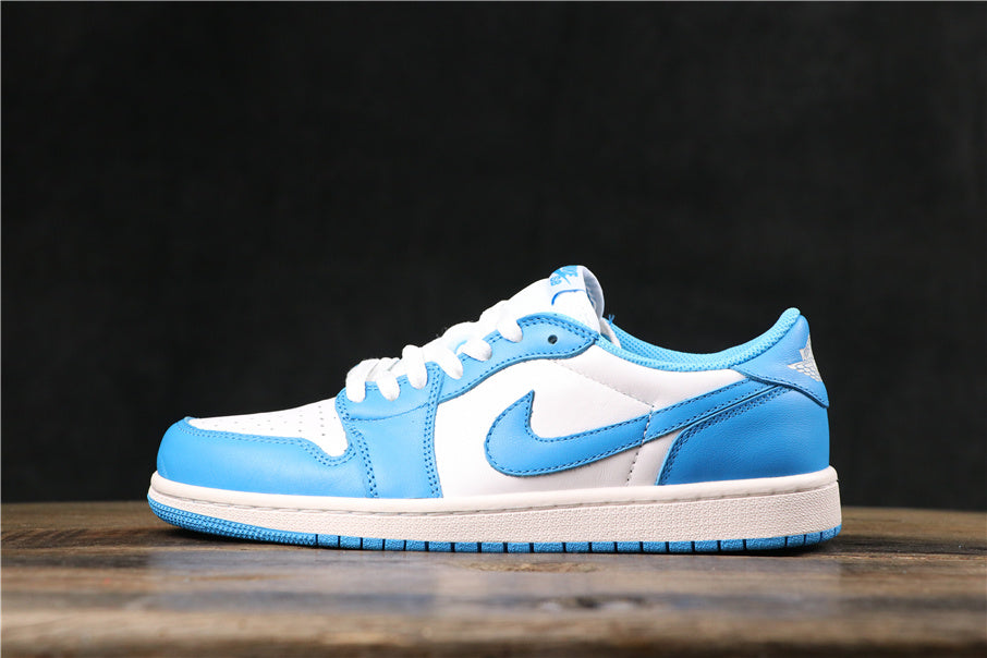 Low-top white and North Carolina blue sneaker shown in side profile on a wooden surface.