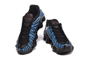 Pair of blue and black Nike Shox-style sneakers viewed from the front.