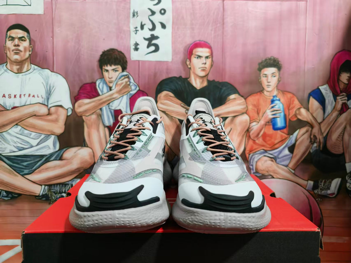 Front view of white and black Under Armour HOVR SLIPSpeed sneakers displayed on a box.