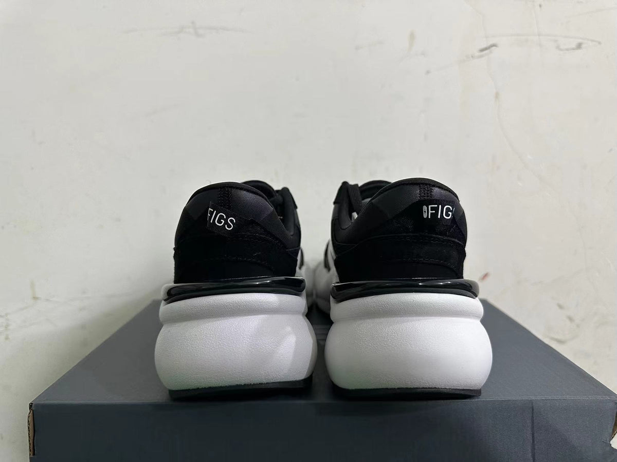 Rear view of black New Balance sneakers with thick white soles