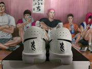Rear view of white Nike sneakers showing black heel Swoosh details, pull tabs, and translucent outsole sections.