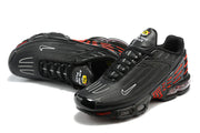 Angled view of black Nike Air Max Plus sneakers with visible Air cushioning