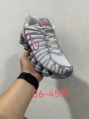 Handheld view of a white, silver-gray, and pink Nike Shox TL-style sneaker; image overlay states size range 36–45.