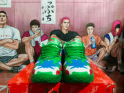 Front view of a pair of green Nike basketball sneakers with blue, white, and red textured panels.