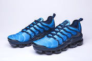 Pair of blue and black Nike Air VaporMax Plus sneakers, front view.