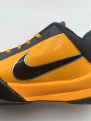Close-up of the orange side panel and black Swoosh with silver outline.