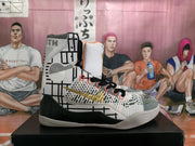 Side profile showing the high-top design, geometric side pattern, gold branding, black midfoot panel, and white outsole.