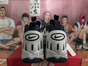 Rear view of white and navy Nike sneakers