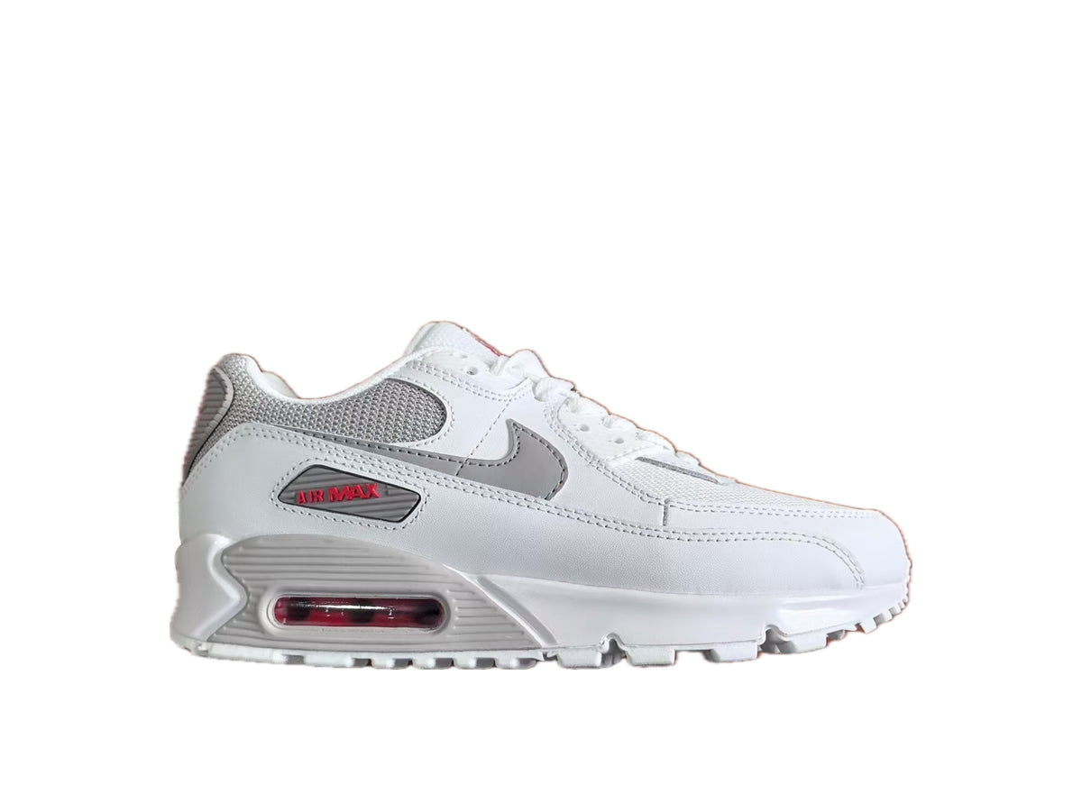 Side view of a white and grey Nike Air Max sneaker with red accents and a visible heel air unit.