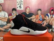 Side view of a black, white, and red Nike basketball shoe.