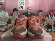 Front view of the magenta sneaker pair showing tonal laces, dark toe caps, and contrasting white midsoles.