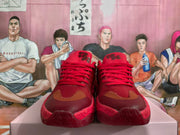 Front view of red lace-up basketball-style sneakers with contrasting toe overlays.