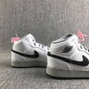 Close three-quarter view of the pair highlighting the black Swoosh, winged ankle branding, and grey laces.