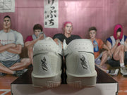 Rear view showing the perforated heel panels and Nike script on the grey shoes.