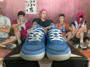 Front view of blue basketball sneakers with white laces, white side accents, and light-colored soles.