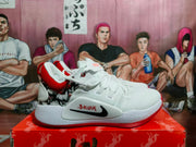 Side view of a white Nike basketball shoe with a black Swoosh, red accents, and a patterned heel panel.