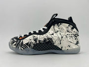 Black and white abstract-pattern high-top sneaker with an orange swoosh.