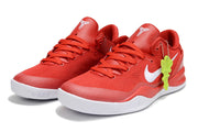 Pair of red Kobe 8 sneakers with white swooshes and a bright green decorative attachment.