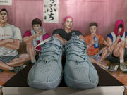 Front view of blue-gray Nike sneakers showing the perforated toe boxes, laces, and padded tongues.