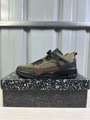 Single side profile of the green and black sneaker resting on a black-and-white patterned shoe box.