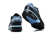 Rear and outsole views of Nike Air Max sneakers with light blue accents