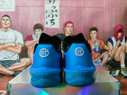 Rear view of the blue sneakers showing padded collars and circular GT heel emblems.