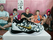 Side profile of one sneaker showing the patterned upper, gold swoosh, black heel section and white midsole.