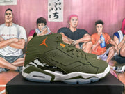 Side profile of an olive green Jordan high-top sneaker with orange Jumpman branding and a white midsole