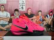 Close angled view of the pink Nike basketball sneakers with side Swoosh branding and black traction outsole.