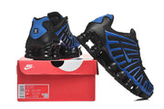 Black and blue Nike Shox sneakers displayed on a red Nike shoe box