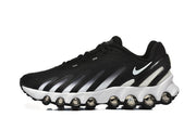 Side profile of a black Nike sneaker with white accents and circular elements along the sole.