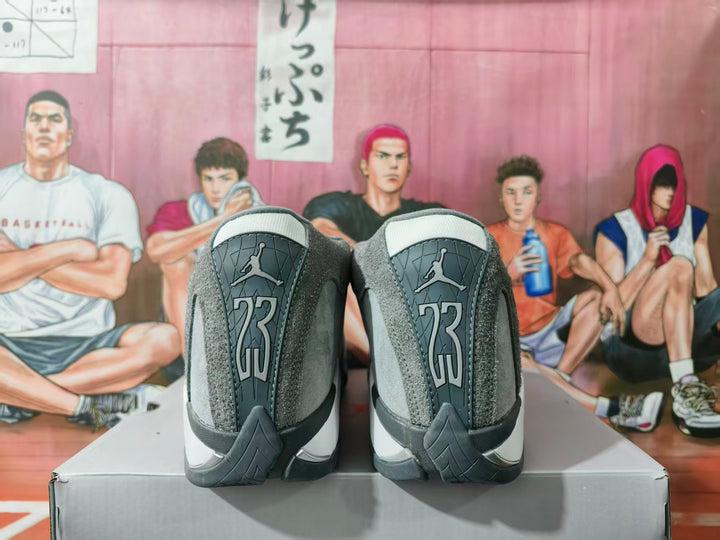 Rear view of gray and white high-top sneakers showing Jumpman heel branding and layered heel panels.