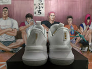 Rear view of the white basketball sneakers showing padded heel collars, heel branding details, and translucent-looking outsoles.