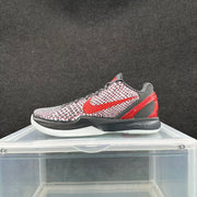 Side view of the sneaker with a red Nike Swoosh, patterned upper, dark midsole and red heel accent.