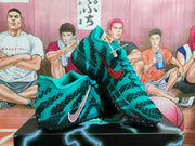 Pair of teal and black Nike basketball sneakers displayed on a box, showing the patterned uppers, side Swoosh, and textured outsoles.